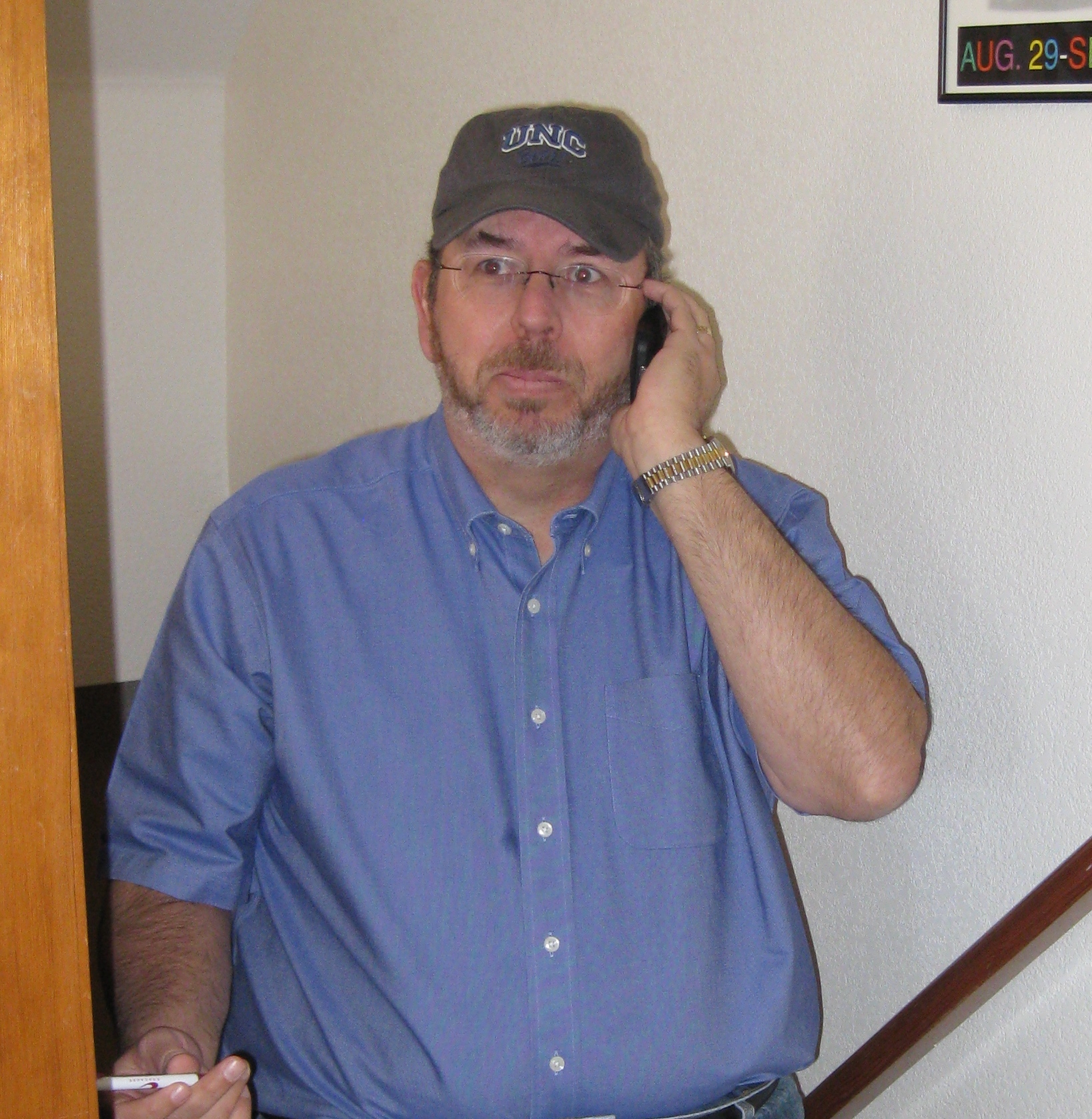 Russ on Stairs A picture of Russ Poulin on the stairs on teh cell phone