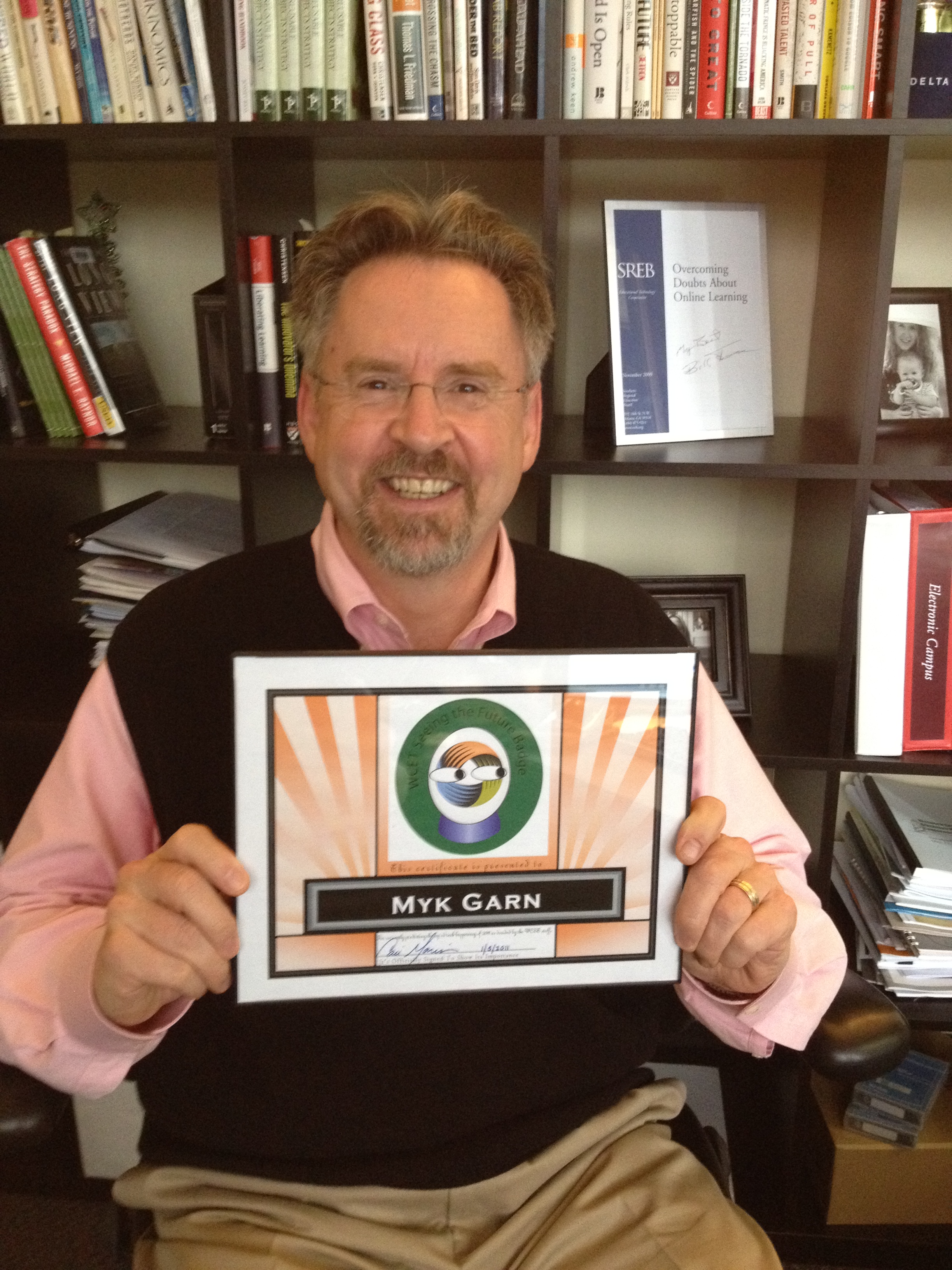 Myk with badge Myk Garn holding a certificate