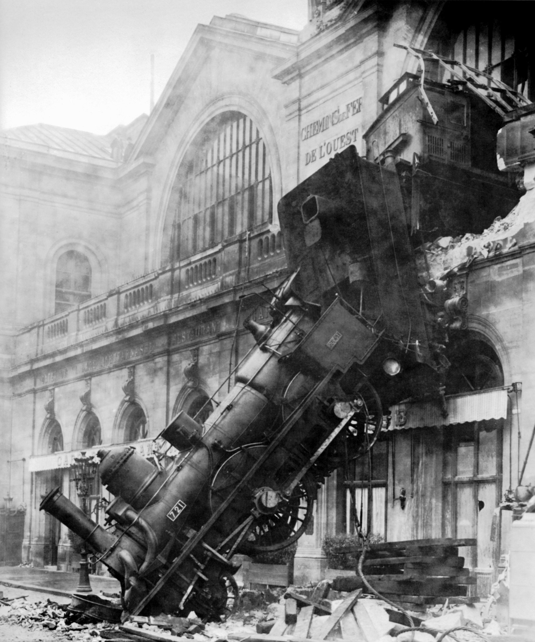 Train_wreck_at_Montparnasse_1895 Photo of a train engine that has crashed comletely through the wall of a train station.