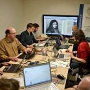 Photo of faculty working together on a computer-mediated class.
