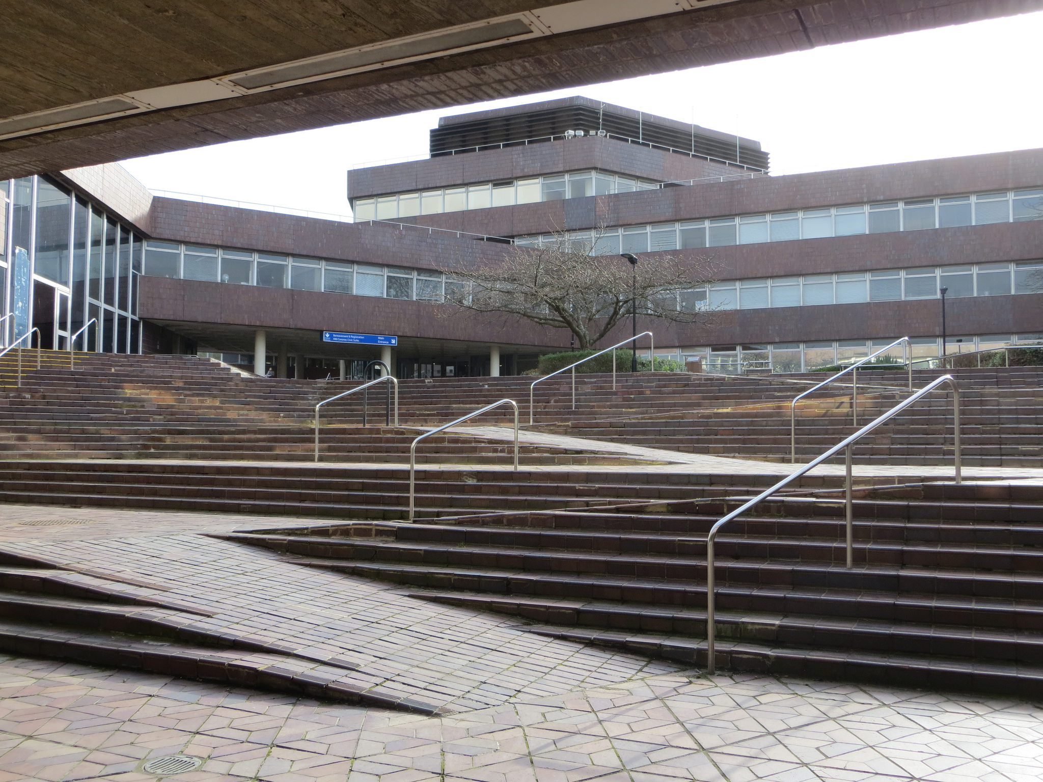 SEveral sets of stairs with a ramp built into the stairway, instead of placed over it (retrofitted)