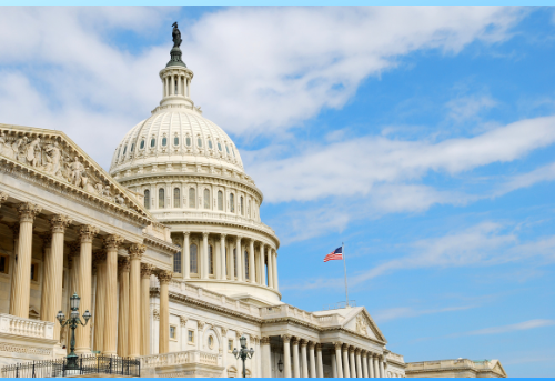 Photo of US capitol building with a bright blue sky dotted with clouds.