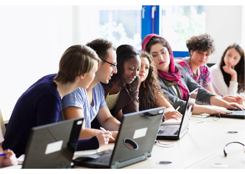 Several college-aged students using laptops