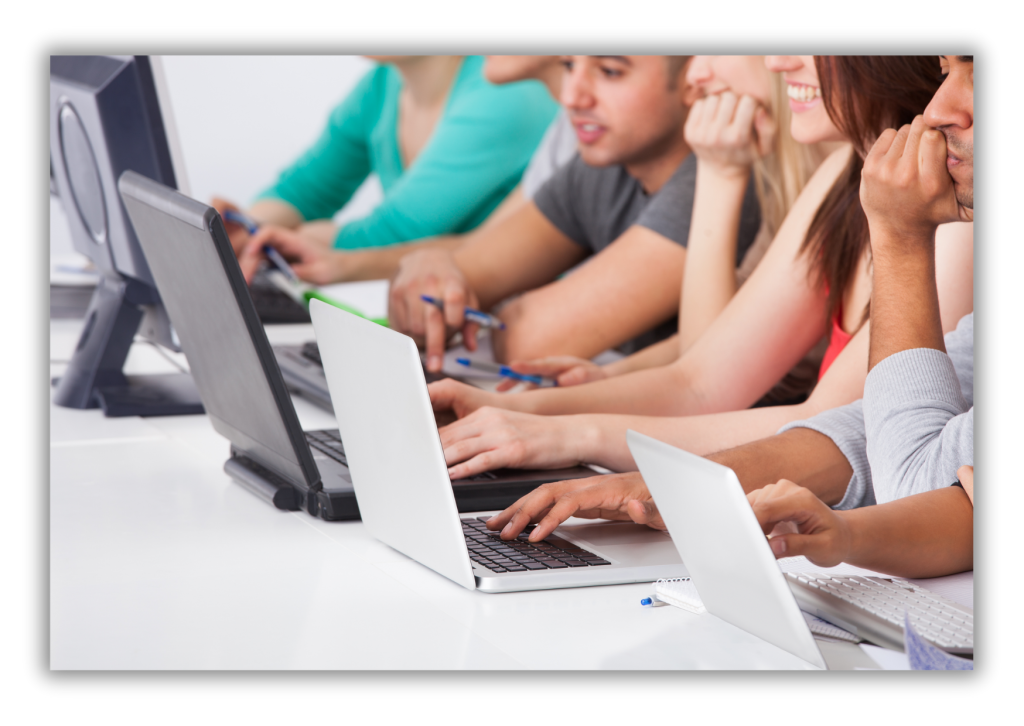 Five college-aged students sitting at laptop/tablet devices 